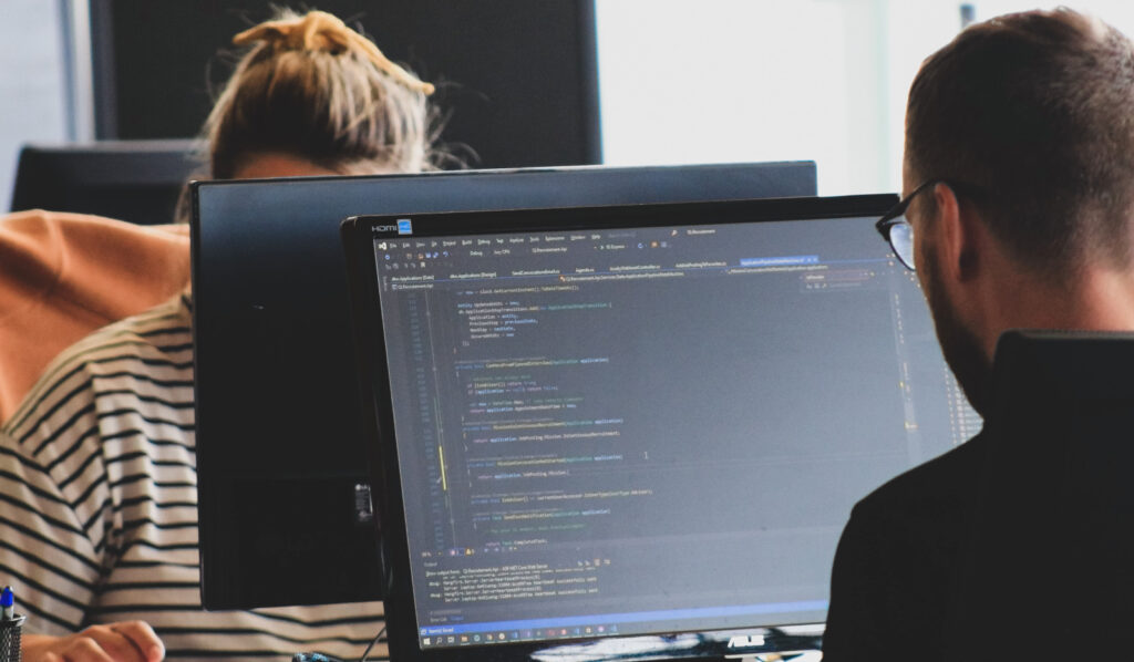 two person in front of a computer